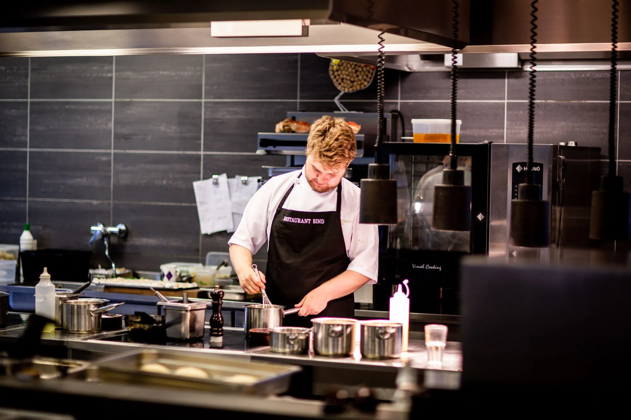 A chef working the line in a professional kitchen